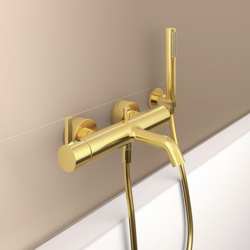 Immagine di Ideal Standard JOY miscelatore monocomando esterno per vasca/doccia, con doccetta a 1 funzione, supporto fisso a muro e flessibile 160 cm, finitura brushed gold BC787A2