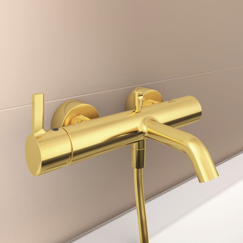 Immagine di Ideal Standard JOY miscelatore monocomando esterno per vasca/doccia, con doccetta a 1 funzione, supporto fisso a muro e flessibile 160 cm, finitura brushed gold BC787A2