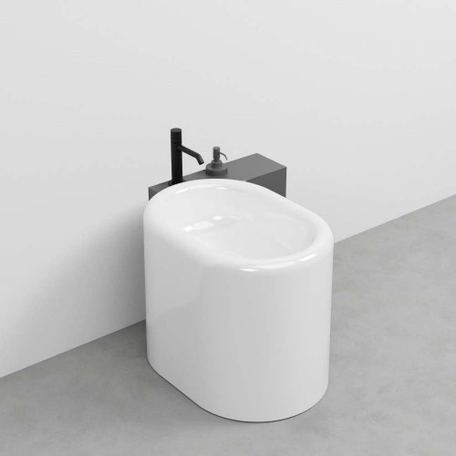 Immagine di Cielo ITACA mensola per bidet a terra in acciaio inox, con foro rubinetto e alloggio dispenser, versione destra, colore cemento finitura opaco ITMBDXCM