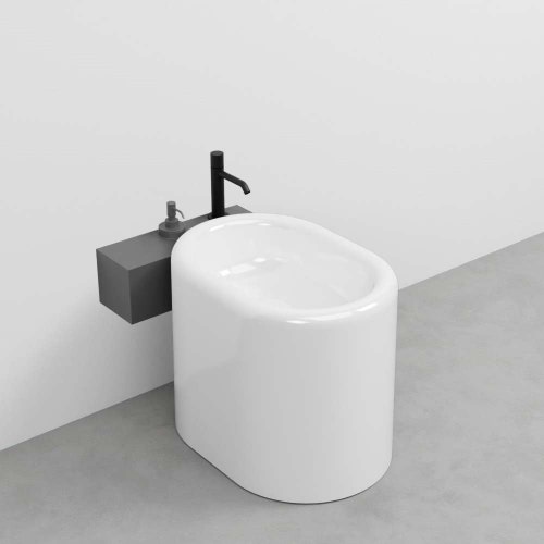 Immagine di Cielo ITACA mensola per bidet a terra in acciaio inox, senza foro rubinetto e alloggio dispenser, versione sinistra, colore cemento finitura opaco ITMBSXSFCM