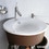 Immagine di Duravit STARCK 1 lavabo consolle 58 cm monoforo, con troppopieno e bordo per rubinetteria, WonderGliss, colore bianco 04065800001