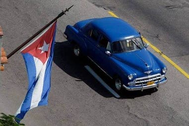 Symbols of Cuba: its flag and a local car