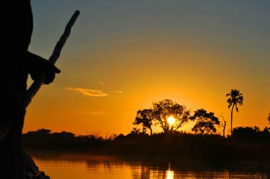 Sunset with poler in Okavango delta