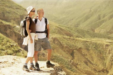 couple-standing-on-top-of-mountain