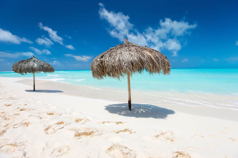 Tropical-thatch-umbrellas-on-a-beautiful-Caribbean-beach