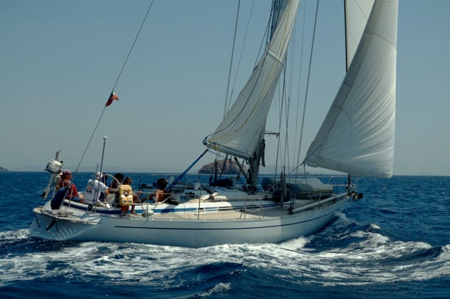 Sailing boat in the amazing sea surrounding the Cyclades in Greece