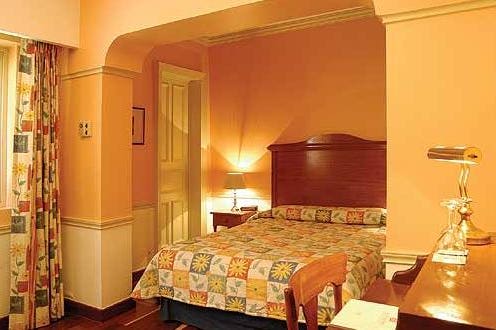 Bedroom of the hotel La Casona in Mexico City